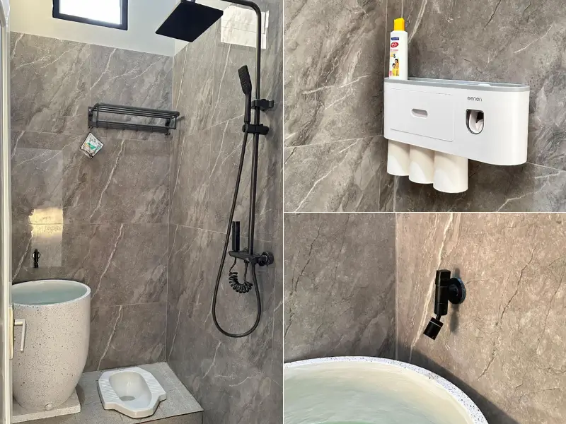 Kamar mandi nuansa abu batu dengan elemen hitam